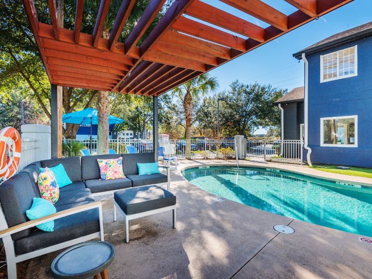 Swimming pool and pergola with seating at NEXTLoft Bluffton, SC apartment rental building